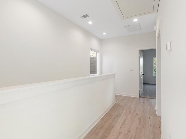 5702 Elysian St, Houston, TX 77009 - corridor featuring attic access, light wood finished floors, healthy amount of natural light, and recessed lighting