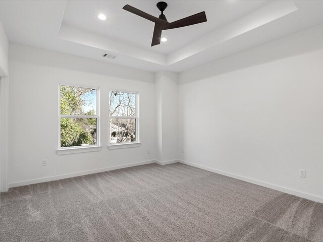 5702 Elysian St, Houston, TX 77009 - carpeted empty room with a tray ceiling, recessed lighting, and a ceiling fan