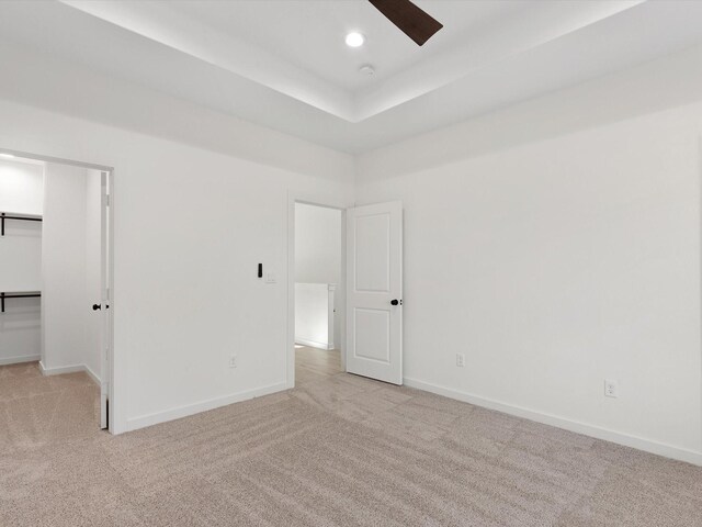 5702 Elysian St, Houston, TX 77009 - unfurnished bedroom with light colored carpet, a walk in closet, ceiling fan, and recessed lighting