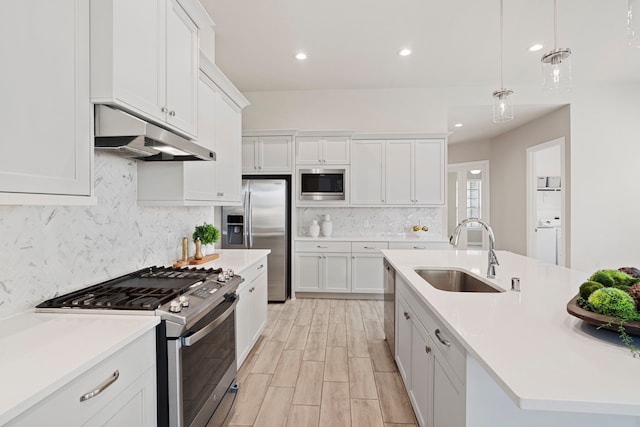 1919 Waters Branch Dr, Missouri City, TX 77459 - kitchen featuring stainless steel appliances, under cabinet range hood, light countertops, decorative backsplash, and recessed lighting