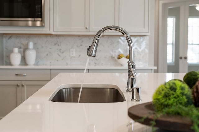 1919 Waters Branch Dr, Missouri City, TX 77459 - kitchen view of stainless steel microwave, light countertops, and decorative backsplash