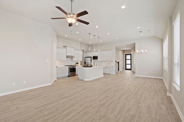 1919 Waters Branch Dr, Missouri City, TX 77459 - unfurnished living room with a ceiling fan, light wood-style floors, recessed lighting, and a chandelier