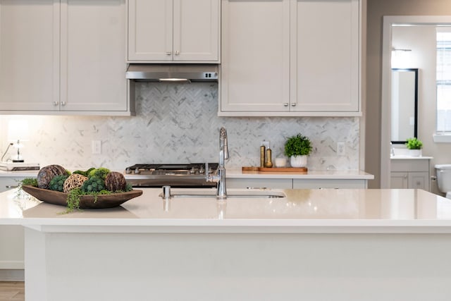 1919 Waters Branch Dr, Missouri City, TX 77459 - kitchen with range hood, tasteful backsplash, and light countertops