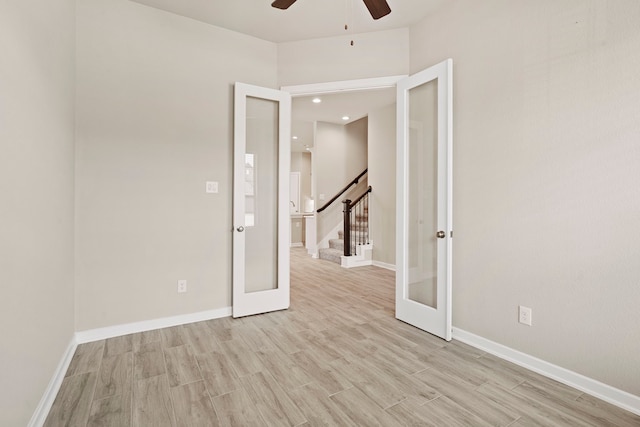 1919 Waters Branch Dr, Missouri City, TX 77459 - empty room featuring a ceiling fan, light wood-type flooring, french doors, stairway, and recessed lighting