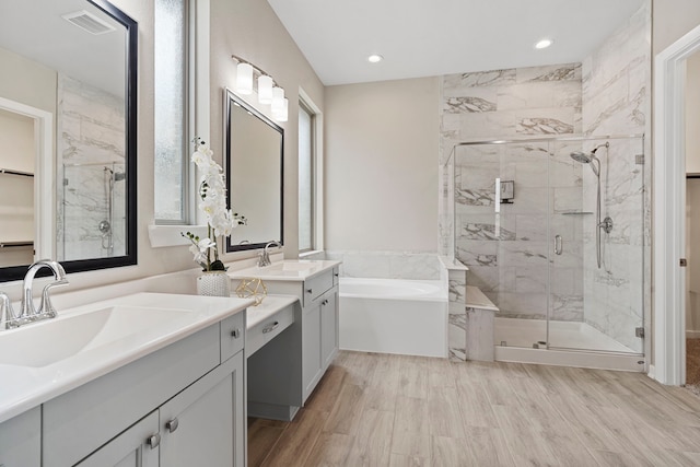 1919 Waters Branch Dr, Missouri City, TX 77459 - bathroom with a shower stall, a garden tub, vanity, wood finished floors, and recessed lighting
