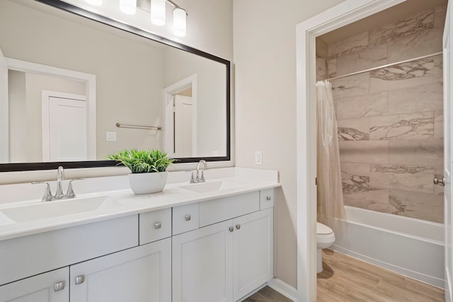 1919 Waters Branch Dr, Missouri City, TX 77459 - bathroom featuring double vanity, wood finished floors, and shower / bath combination with curtain