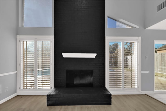 15810 Parksley Dr, Houston, TX 77059 - unfurnished living room with a towering ceiling, wood finished floors, and a fireplace
