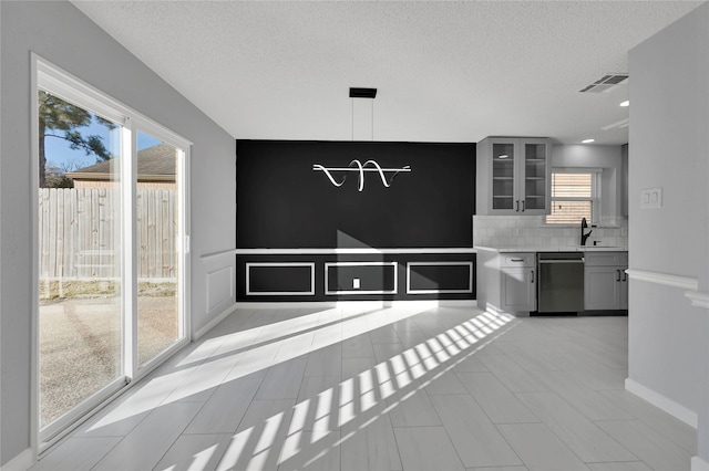 15810 Parksley Dr, Houston, TX 77059 - unfurnished dining area featuring plenty of natural light, a textured ceiling, and light tile patterned flooring