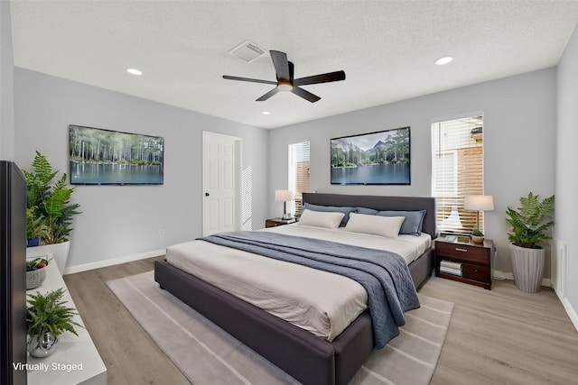 15810 Parksley Dr, Houston, TX 77059 - bedroom featuring light wood finished floors, recessed lighting, a ceiling fan, and a textured ceiling