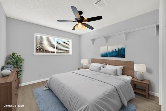 15810 Parksley Dr, Houston, TX 77059 - bedroom with wood finished floors, a textured ceiling, and a ceiling fan