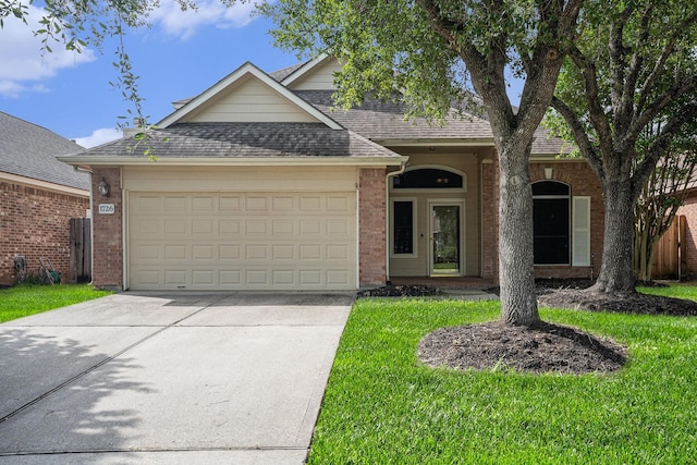 1726 Roaring Springs Ln, Seabrook, TX 77586 - view of front of home with concrete driveway, a garage, roof with shingles, brick siding, and a front yard
