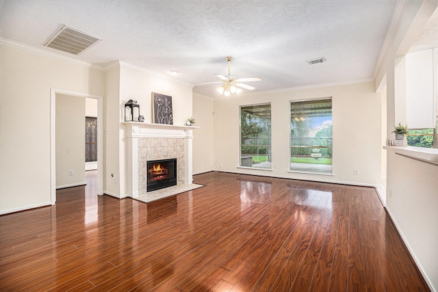 1726 Roaring Springs Ln, Seabrook, TX 77586 - unfurnished living room with healthy amount of natural light, wood finished floors, a ceiling fan, a fireplace, and crown molding