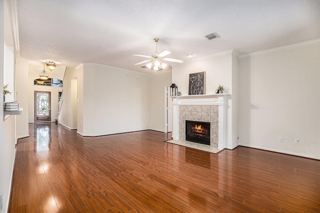 1726 Roaring Springs Ln, Seabrook, TX 77586 - unfurnished living room featuring wood finished floors, a tiled fireplace, ornamental molding, and a ceiling fan