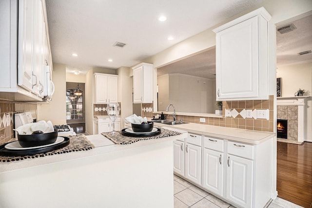 1726 Roaring Springs Ln, Seabrook, TX 77586 - kitchen featuring white cabinetry, decorative backsplash, light countertops, and recessed lighting
