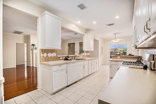 1726 Roaring Springs Ln, Seabrook, TX 77586 - kitchen featuring white appliances, light countertops, a textured ceiling, tasteful backsplash, and recessed lighting