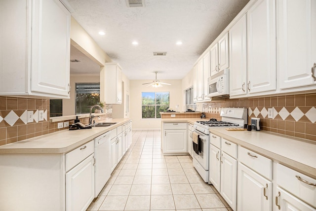 1726 Roaring Springs Ln, Seabrook, TX 77586 - kitchen featuring white appliances, light countertops, tasteful backsplash, white cabinets, and recessed lighting