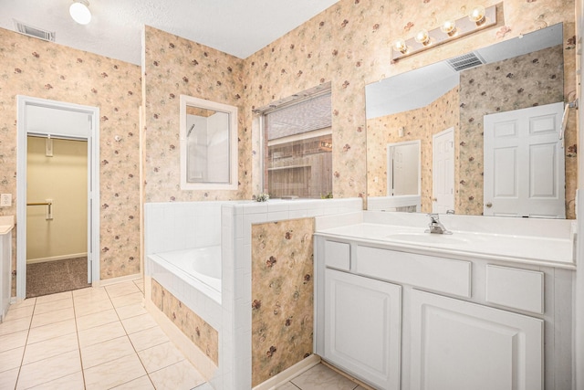1726 Roaring Springs Ln, Seabrook, TX 77586 - bathroom featuring wallpapered walls, a garden tub, tile patterned floors, vanity, and a walk in closet