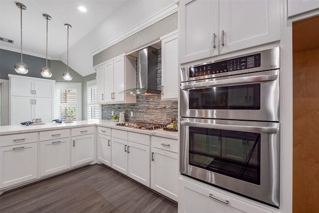 1013 Azalea Pointe, League City, TX 77573 - kitchen with stainless steel appliances, wall chimney exhaust hood, backsplash, white cabinetry, and vaulted ceiling