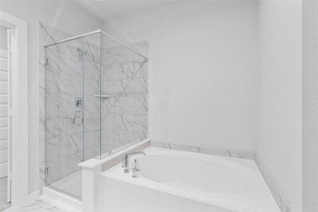 6702 Old Cypress Landing Ln, Humble, TX 77338 - full bathroom with a garden tub, a marble finish shower, a walk in closet, and marble look tiles