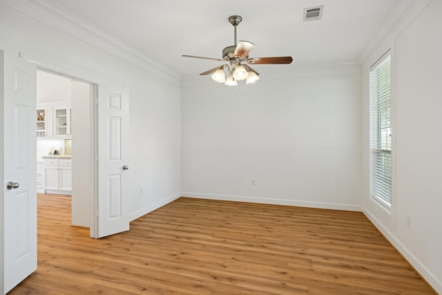34310 High Point Dr, Magnolia, TX 77355 - spare room featuring ornamental molding, light wood-type flooring, and ceiling fan