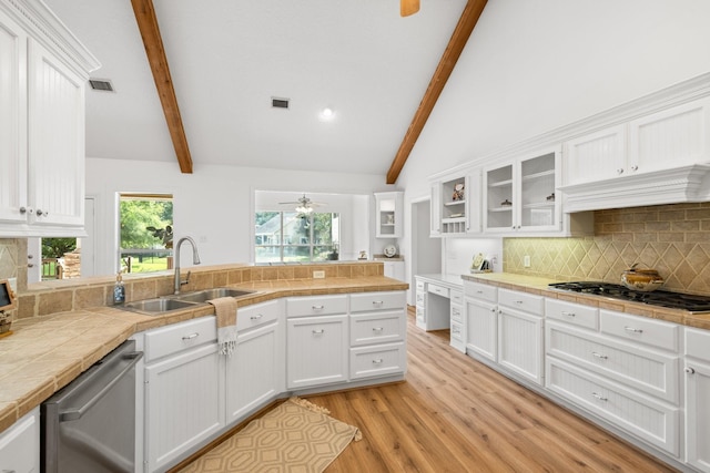 34310 High Point Dr, Magnolia, TX 77355 - kitchen featuring stainless steel appliances, white cabinetry, light wood-style floors, a ceiling fan, and tasteful backsplash