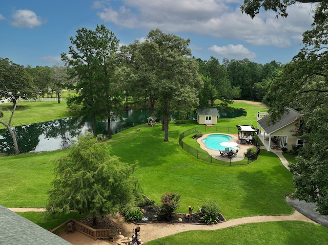 34310 High Point Dr, Magnolia, TX 77355 - view of home's community featuring a water view, an outbuilding, a pool, and a patio area