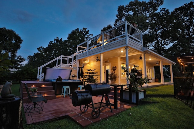 34310 High Point Dr, Magnolia, TX 77355 - back of house with a hot tub, a ceiling fan, a deck, a lawn, and a balcony