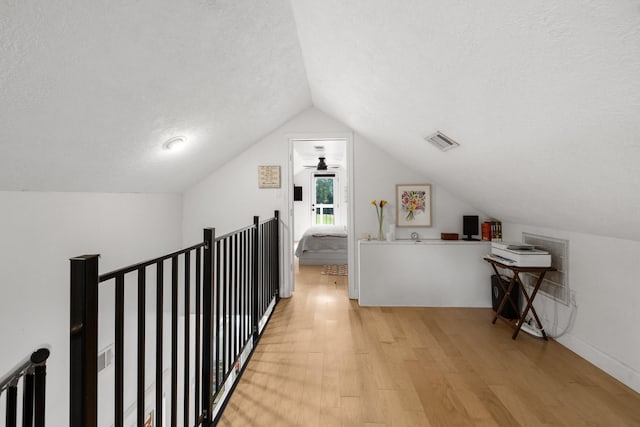 34310 High Point Dr, Magnolia, TX 77355 - bonus room featuring light wood-style floors, a textured ceiling, and vaulted ceiling