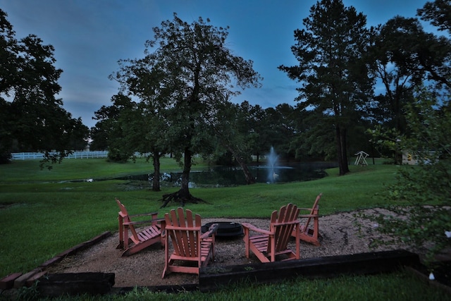 34310 High Point Dr, Magnolia, TX 77355 - view of green lawn with a fire pit and a water view