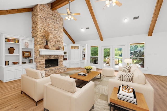 34310 High Point Dr, Magnolia, TX 77355 - living room featuring a ceiling fan, beamed ceiling, light wood finished floors, a stone fireplace, and high vaulted ceiling
