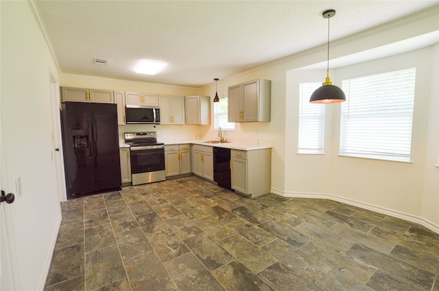 154 Wood Manor Ln, Sour Lake, TX 77659 - kitchen featuring black appliances, crown molding, dark stone finish floors, hanging light fixtures, and light countertops