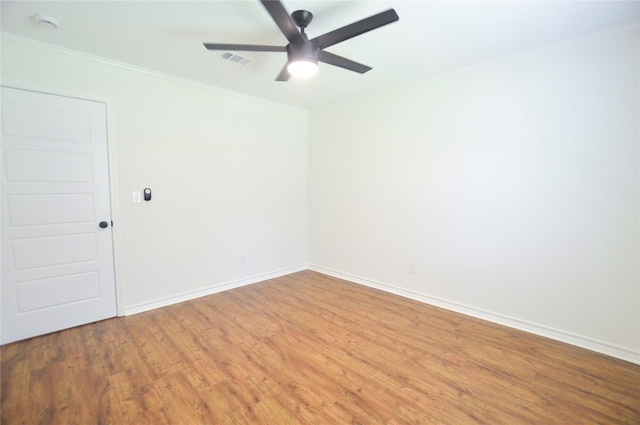 154 Wood Manor Ln, Sour Lake, TX 77659 - empty room featuring wood finished floors, ceiling fan, crown molding, and a smoke detector