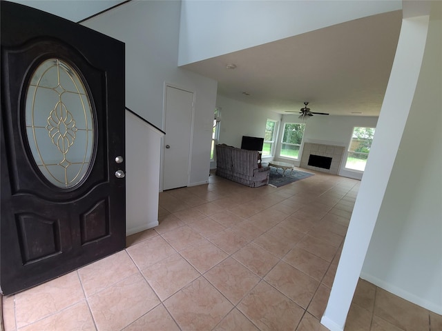 6322 Northland Dr, Houston, TX 77084 - foyer entrance with light tile patterned floors, a fireplace, a ceiling fan, and stairs