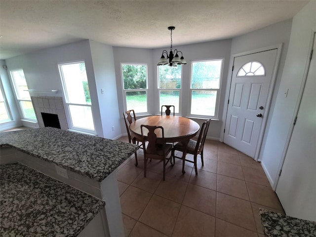 6322 Northland Dr, Houston, TX 77084 - tiled dining space with a chandelier and a fireplace