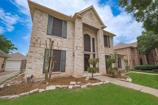 10818 Kleberg Place Dr, Houston, TX 77064 - view of front facade featuring a front yard, brick siding, and a detached garage