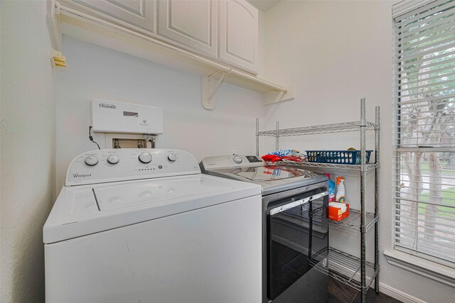 10818 Kleberg Place Dr, Houston, TX 77064 - laundry area with washing machine and clothes dryer, healthy amount of natural light, and cabinet space