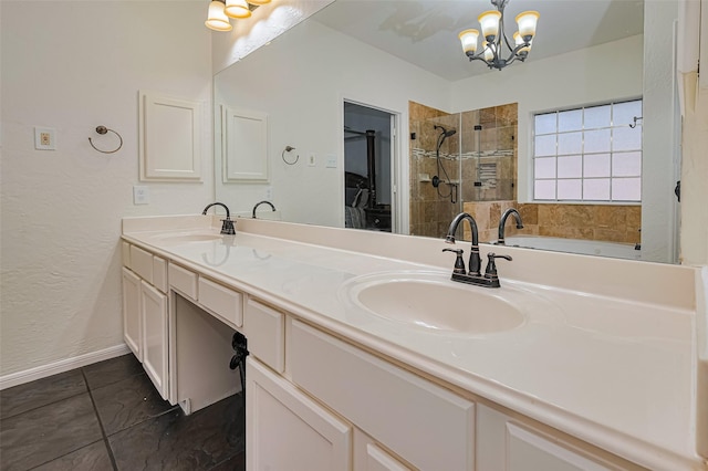 10818 Kleberg Place Dr, Houston, TX 77064 - full bathroom with a chandelier, a stall shower, double vanity, a walk in closet, and a textured wall