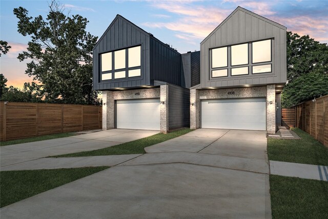4110 Cortlandt St, Houston, TX 77018 - contemporary house with an attached garage, board and batten siding, concrete driveway, and brick siding