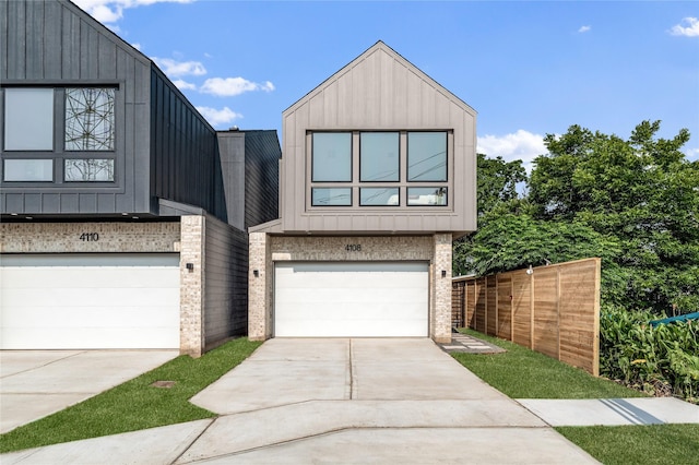 4110 Cortlandt St, Houston, TX 77018 - contemporary house featuring a garage, driveway, brick siding, and board and batten siding