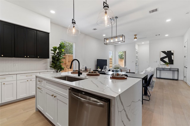 4110 Cortlandt St, Houston, TX 77018 - kitchen with stainless steel dishwasher, an island with sink, open floor plan, a ceiling fan, and light wood finished floors