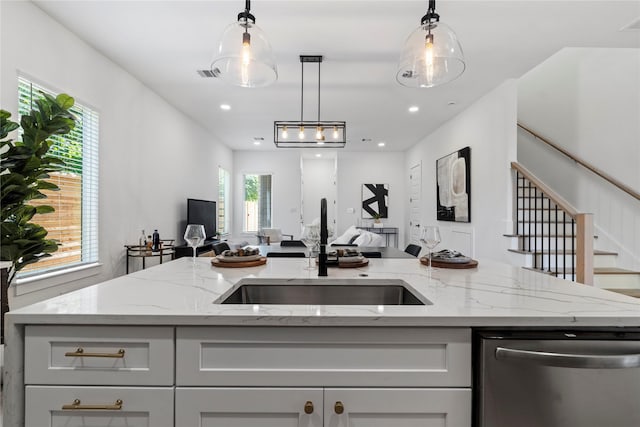 4110 Cortlandt St, Houston, TX 77018 - kitchen with stainless steel dishwasher, open floor plan, decorative light fixtures, light stone countertops, and recessed lighting