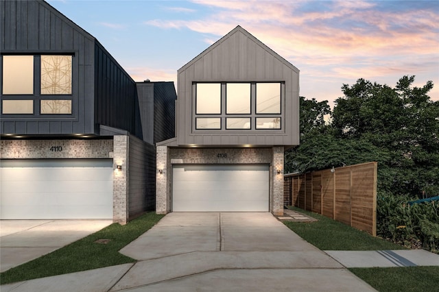 4110 Cortlandt St, Houston, TX 77018 - contemporary house featuring an attached garage, driveway, brick siding, and board and batten siding