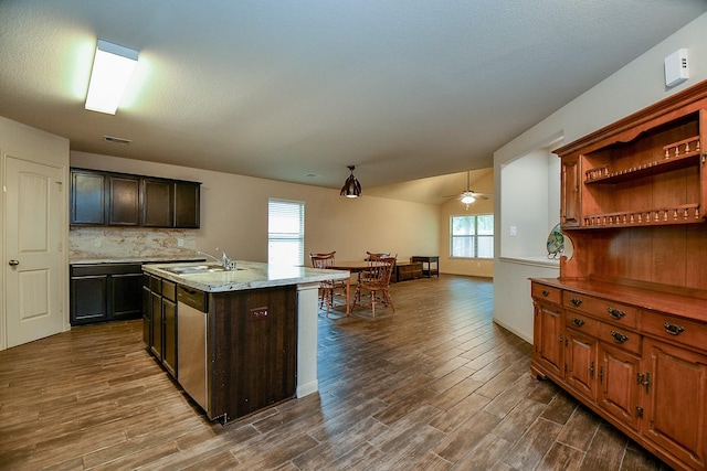 2026 Naplechase Crest Dr, Spring, TX 77373 - kitchen with dark wood-type flooring, an island with sink, ceiling fan, decorative backsplash, and dishwasher