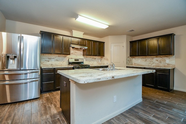 2026 Naplechase Crest Dr, Spring, TX 77373 - kitchen with stainless steel appliances, dark wood-type flooring, dark brown cabinets, and under cabinet range hood