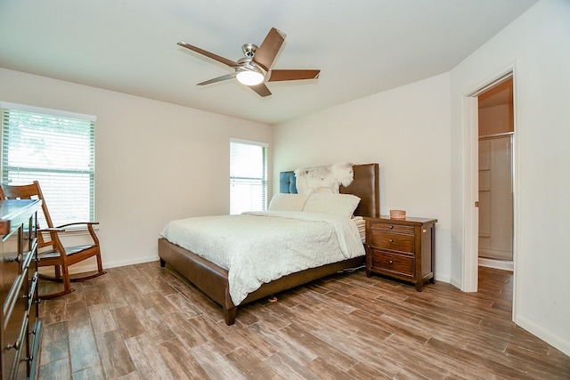 2026 Naplechase Crest Dr, Spring, TX 77373 - bedroom with wood finished floors, a ceiling fan, and ensuite bathroom