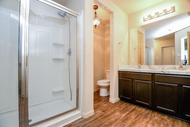 2026 Naplechase Crest Dr, Spring, TX 77373 - bathroom featuring a shower stall, double vanity, and wood finished floors