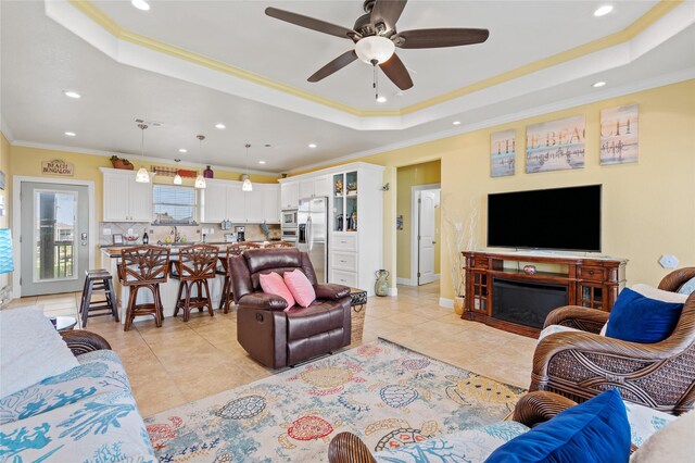 2617 Breaker Dr, Port Bolivar, TX 77650 - living area with a tray ceiling, ornamental molding, recessed lighting, light tile patterned floors, and ceiling fan
