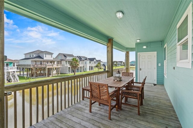 2617 Breaker Dr, Port Bolivar, TX 77650 - wooden terrace with a water view, a residential view, and outdoor dining area