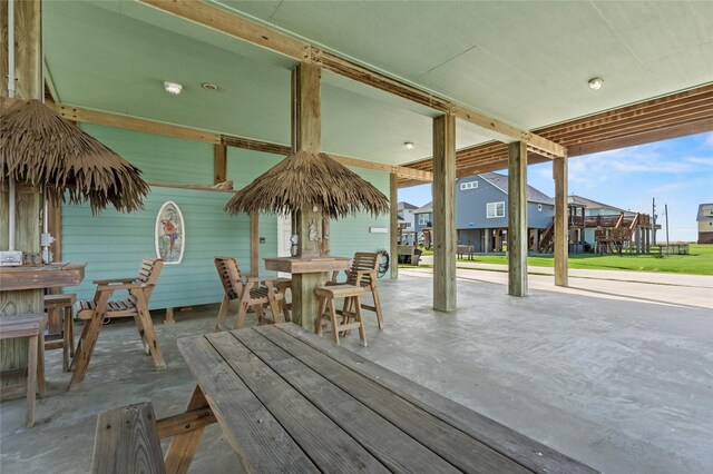2617 Breaker Dr, Port Bolivar, TX 77650 - wooden terrace featuring outdoor dining area, a patio area, and a residential view