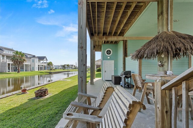 2617 Breaker Dr, Port Bolivar, TX 77650 - view of patio / terrace featuring area for grilling, a fire pit, a water view, and a residential view